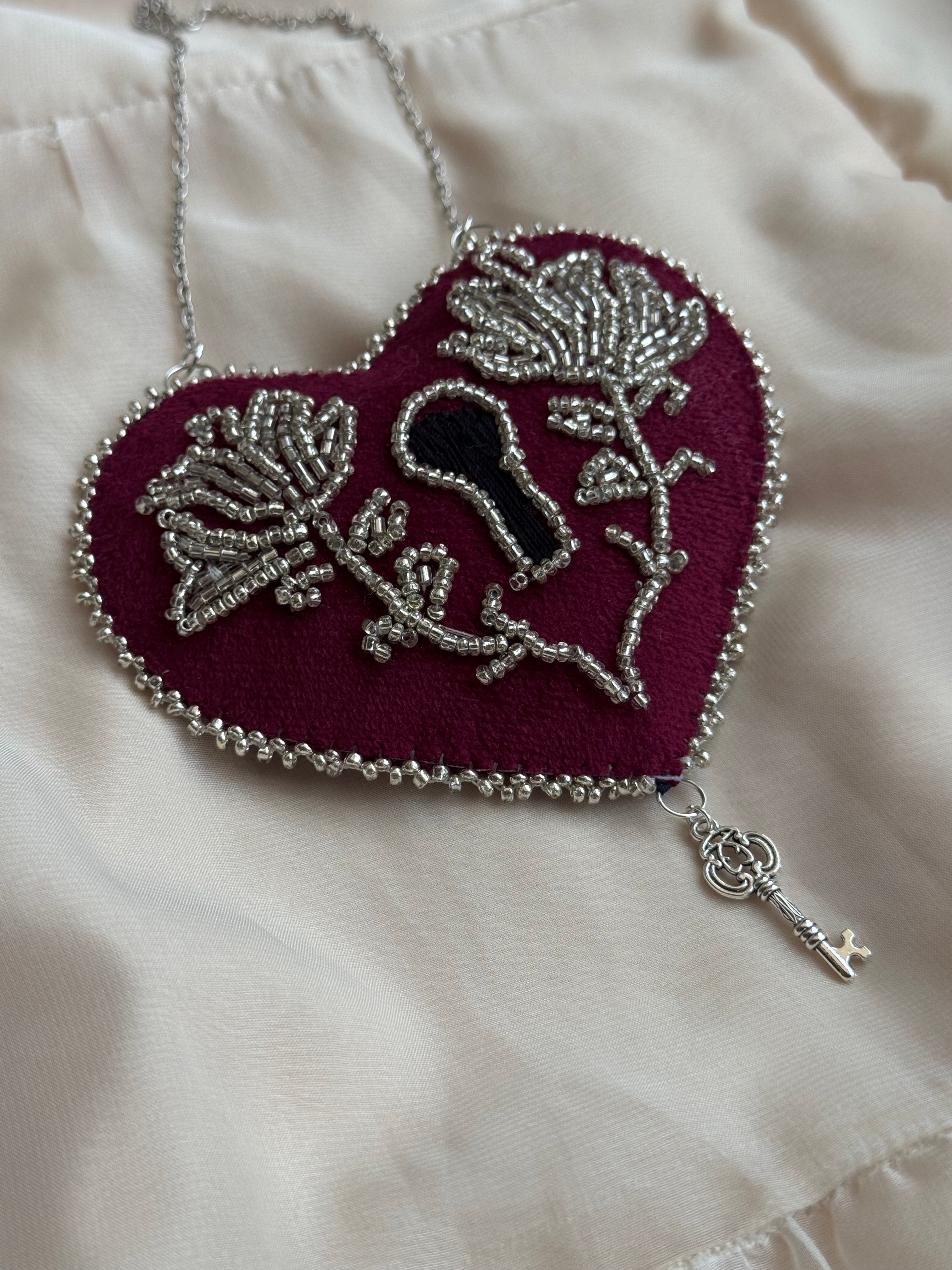 Decorative brooch with floral design on a white fabric background