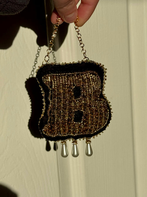 Hand-beaded Anne Boleyn "B" monogram wall hanging in gold glass beads on black velvet with three teardrop pearls.