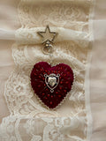 Heart-shaped pendant with star charm on a lace background