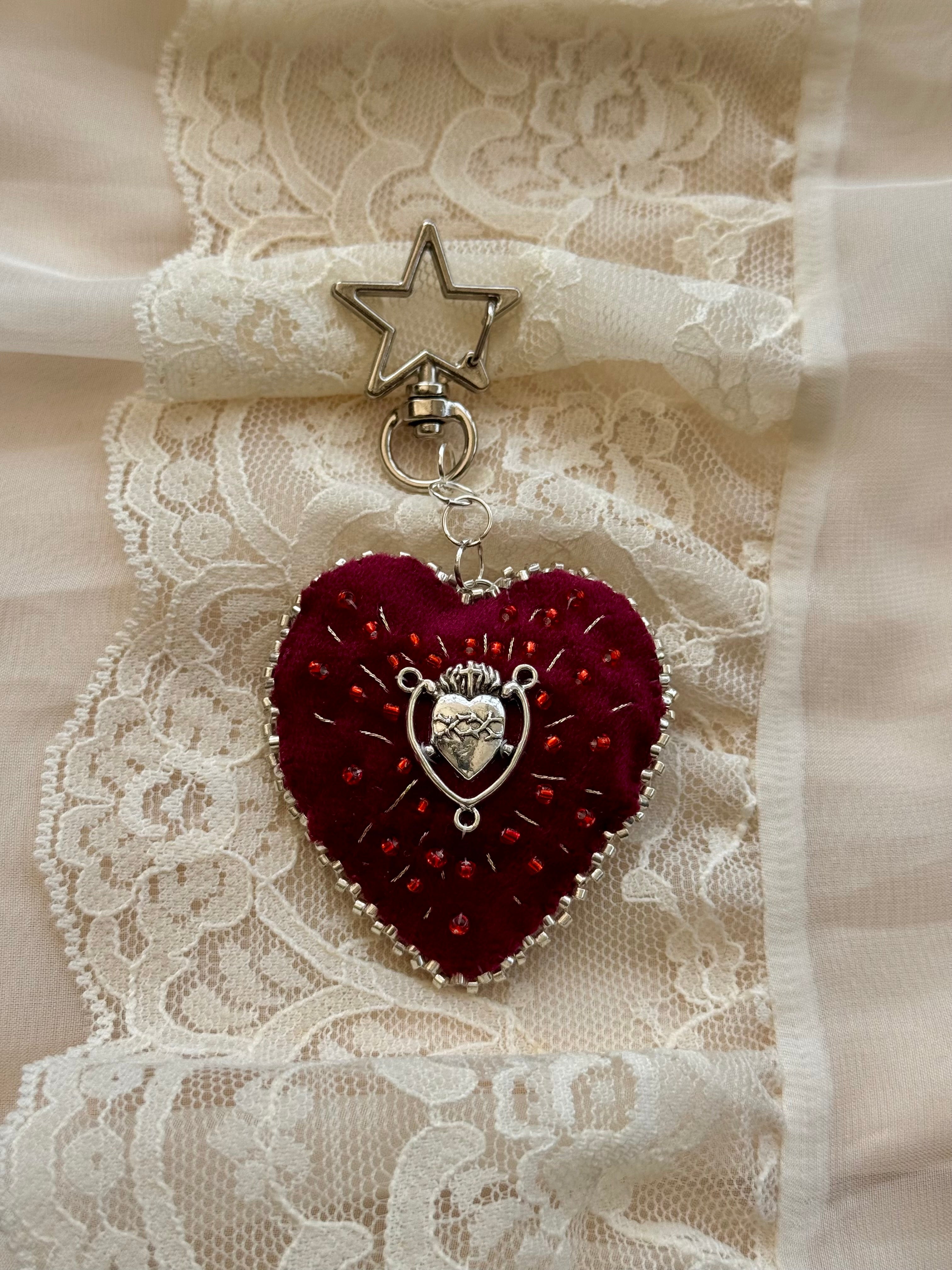 Heart-shaped pendant with star charm on a lace background