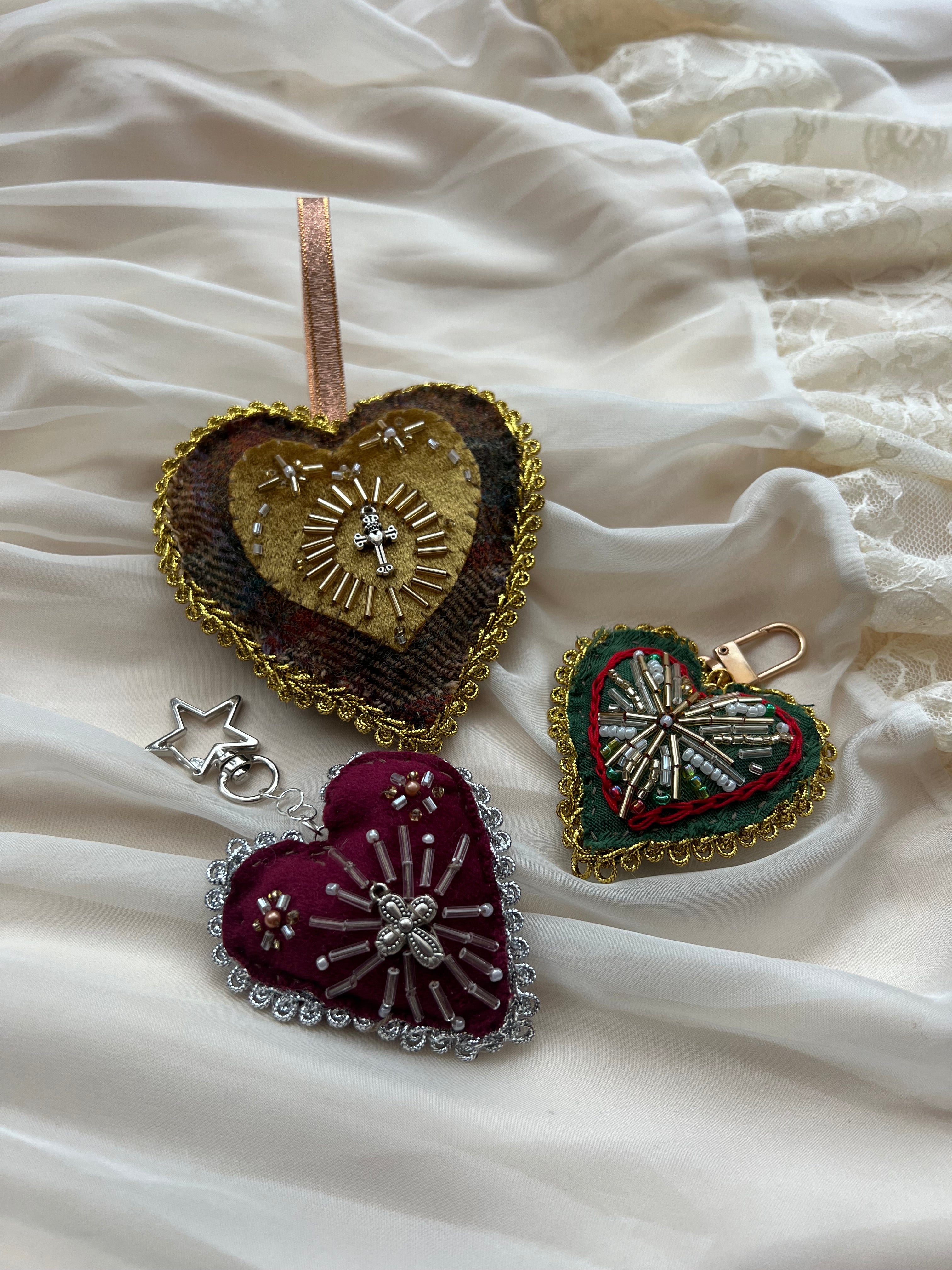 Heart-shaped brooches on a textured white fabric background