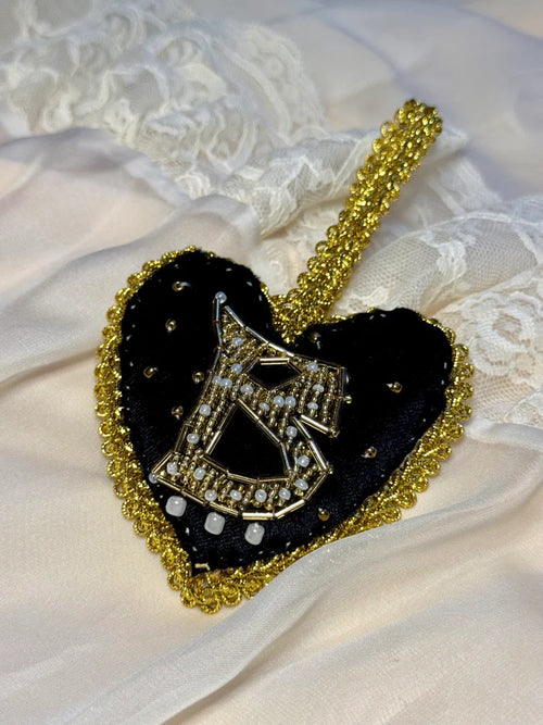Heart-shaped pendant with gold chain on a white lace background