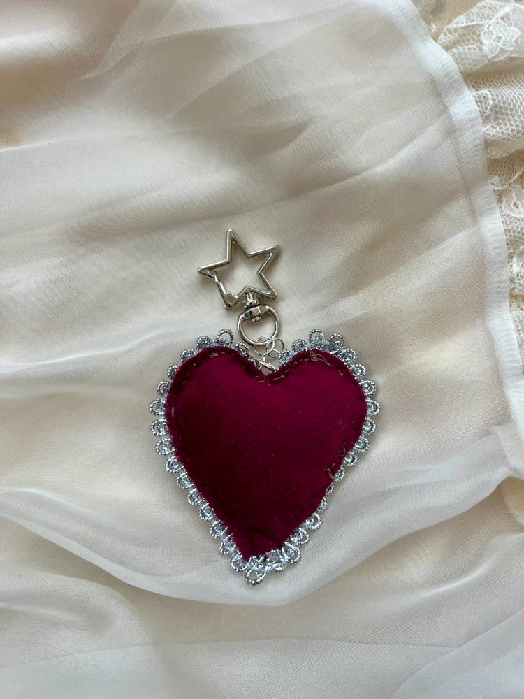 Heart-shaped pendant with star on a white fabric background