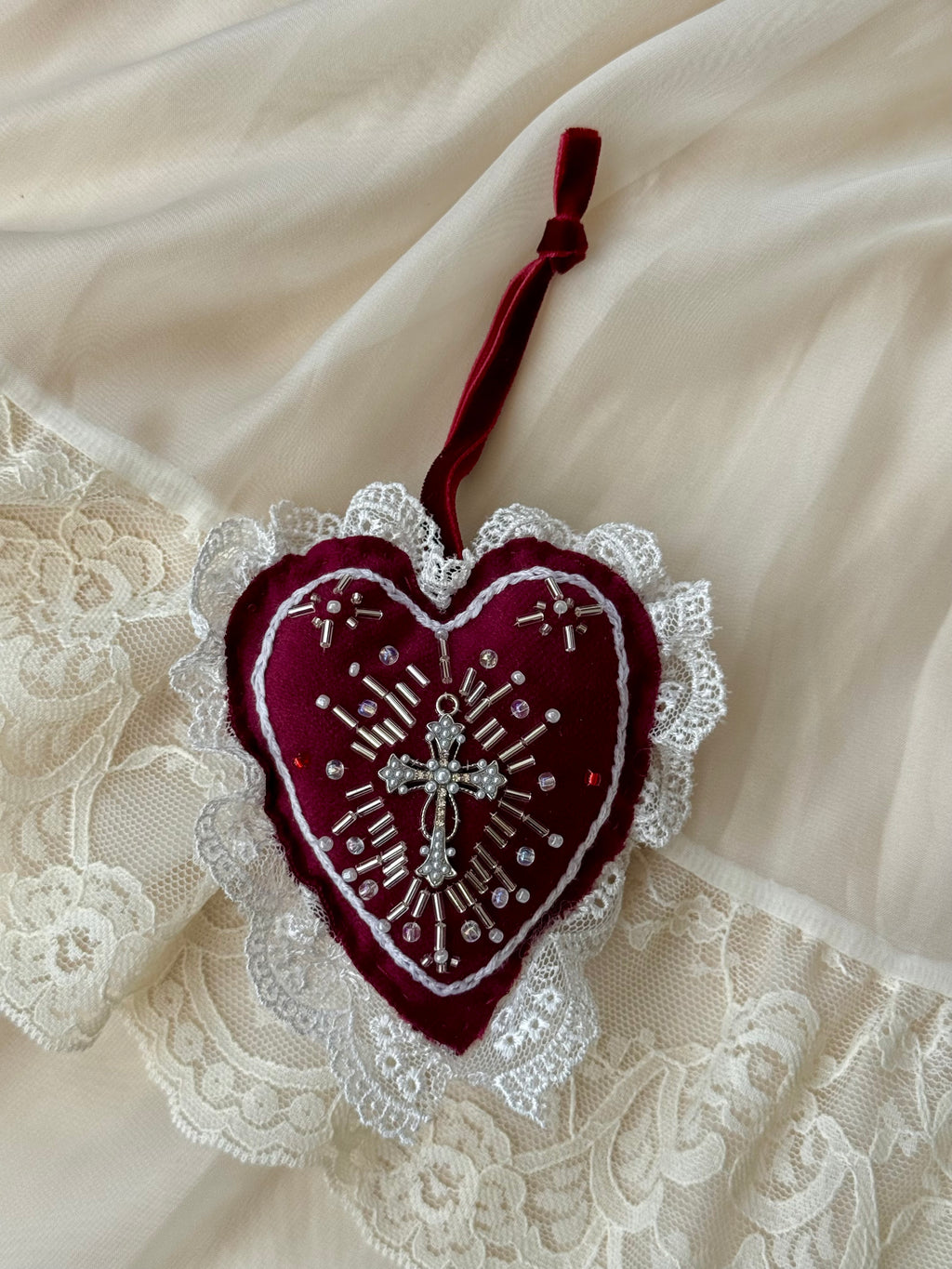 Decorative heart ornament with lace details on a lace background